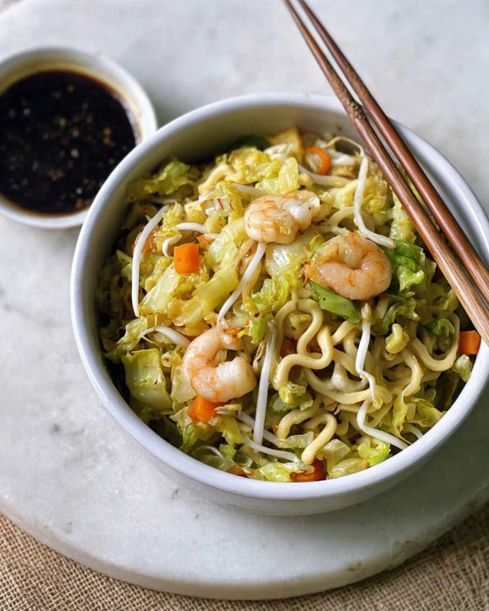 The image shows a white bowl filled with a cooked noodle dish, with three main layers visible: the bottom layer consists of light yellow noodles mixed with some bean sprouts, the middle layer has light green leafy vegetables and sliced light orange carrots, and the top layer is scattered with small white shrimp and green herbs. The texture appears slightly moist and lightly seasoned. Wooden chopsticks rest on the edge of the bowl. Next to the bowl is a small white plate holding dark brown dipping sauce with a thick texture, and a pair of wooden chopsticks are placed inside the sauce. The setting is on a white marbled surface. Photo taken with an iphone --ar 4:5 --v 7