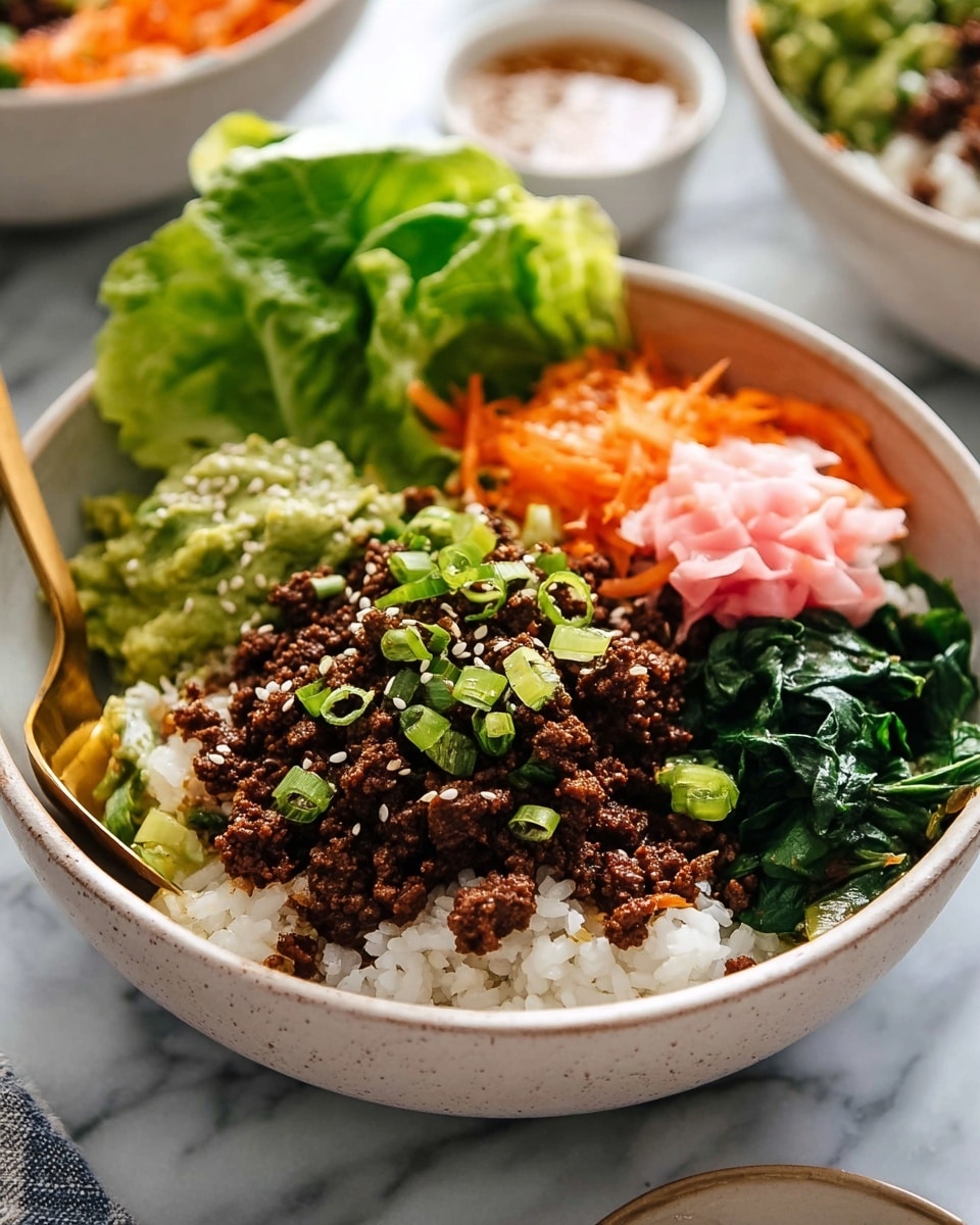 A white bowl sits on a white marbled surface, filled with a colorful, layered dish. The bottom layer is white rice, topped with dark brown cooked ground beef sprinkled with white sesame seeds and small green onion slices scattered over it. Around the beef, there are bright orange shredded carrots on one side, a scoop of chunky green guacamole on another, fresh dark green sautéed spinach, and crisp light green lettuce leaves with a small pink pickled ginger rose. A golden spoon is partially scooping some rice and beef on the right side. In the background, there is a blurred white bowl with sauce and a spoon. Photo taken with an iphone --ar 4:5 --v 7