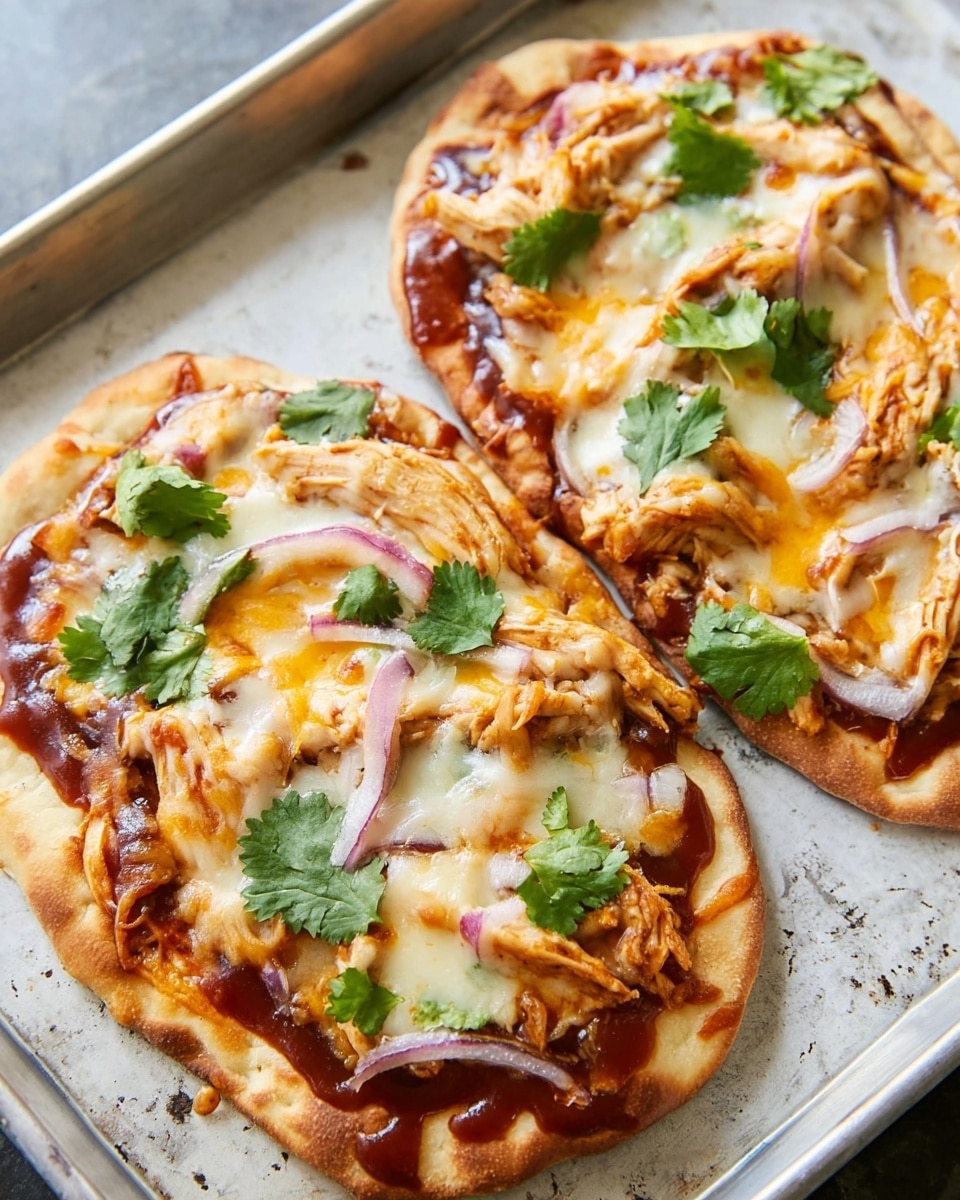 The image shows a flatbread pizza on a metal tray with a white marbled texture surface underneath. The flatbread base is golden brown, topped with a layer of barbecue sauce that is dark reddish-brown. On top of the sauce, there is a mix of melted cheeses in white and light orange colors, creating a rich and gooey texture. Shredded chicken pieces are spread unevenly across the flatbread, adding a tender, pale layer. Thin slices of red onion are scattered, adding a touch of purple. Fresh green cilantro leaves are placed on top as a final garnish. The overall look is warm, cheesy, and colorful. photo taken with an iphone --ar 4:5 --v 7