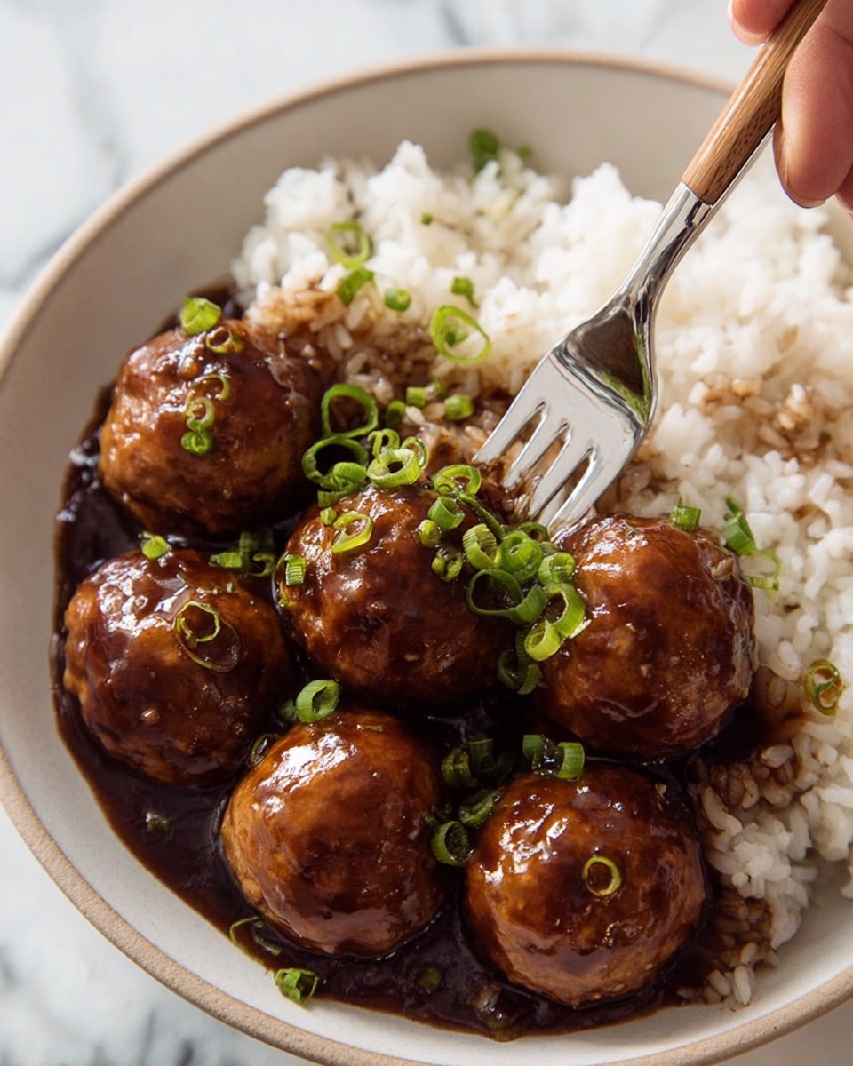 The image shows a white bowl filled with a layer of white rice on one side and a layer of dark brown sauce with some grains mixed in it on the other side. On top of the sauce are six shiny, brown glazed meatballs, each with a smooth and moist texture. Bright green chopped chives are sprinkled over the meatballs, adding a fresh contrast. A woman’s hand is visible, holding a fork that is piercing one meatball at the center. The background is a white marbled texture. photo taken with an iphone --ar 4:5 --v 7
